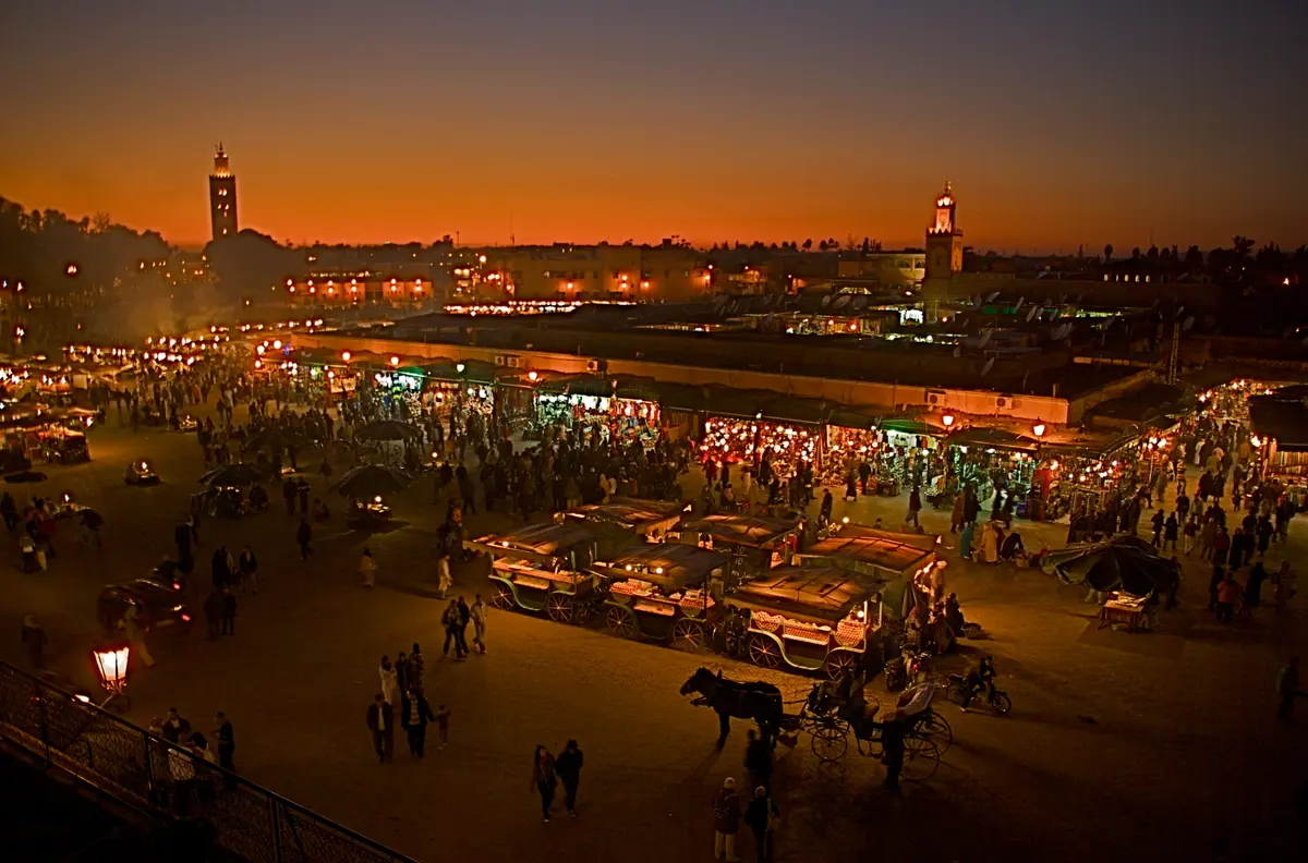 Jemaa el-Fnaa square in Marrakech lit up at dusk