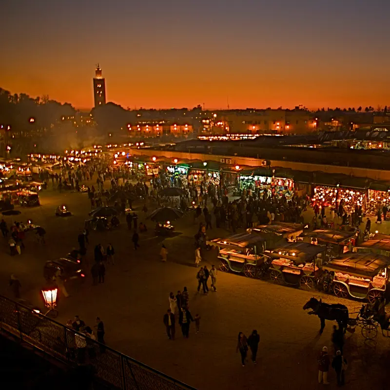Jemaa el-Fnaa square at dusk, with the Koutoubia beyond