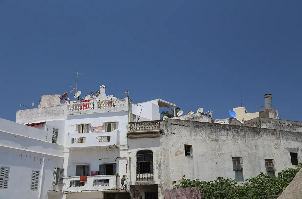 Whitewashed houses stacked above the Tangier bay