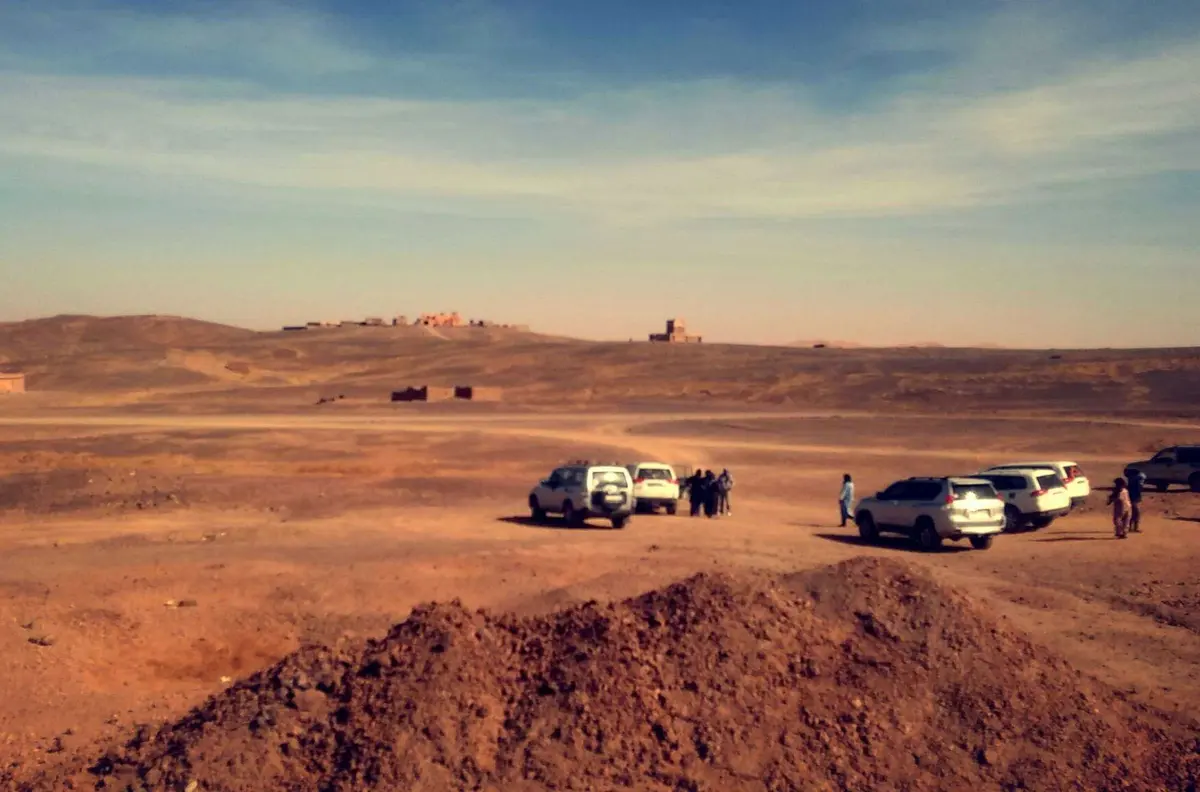 A 4x4 running out across the desert at first light